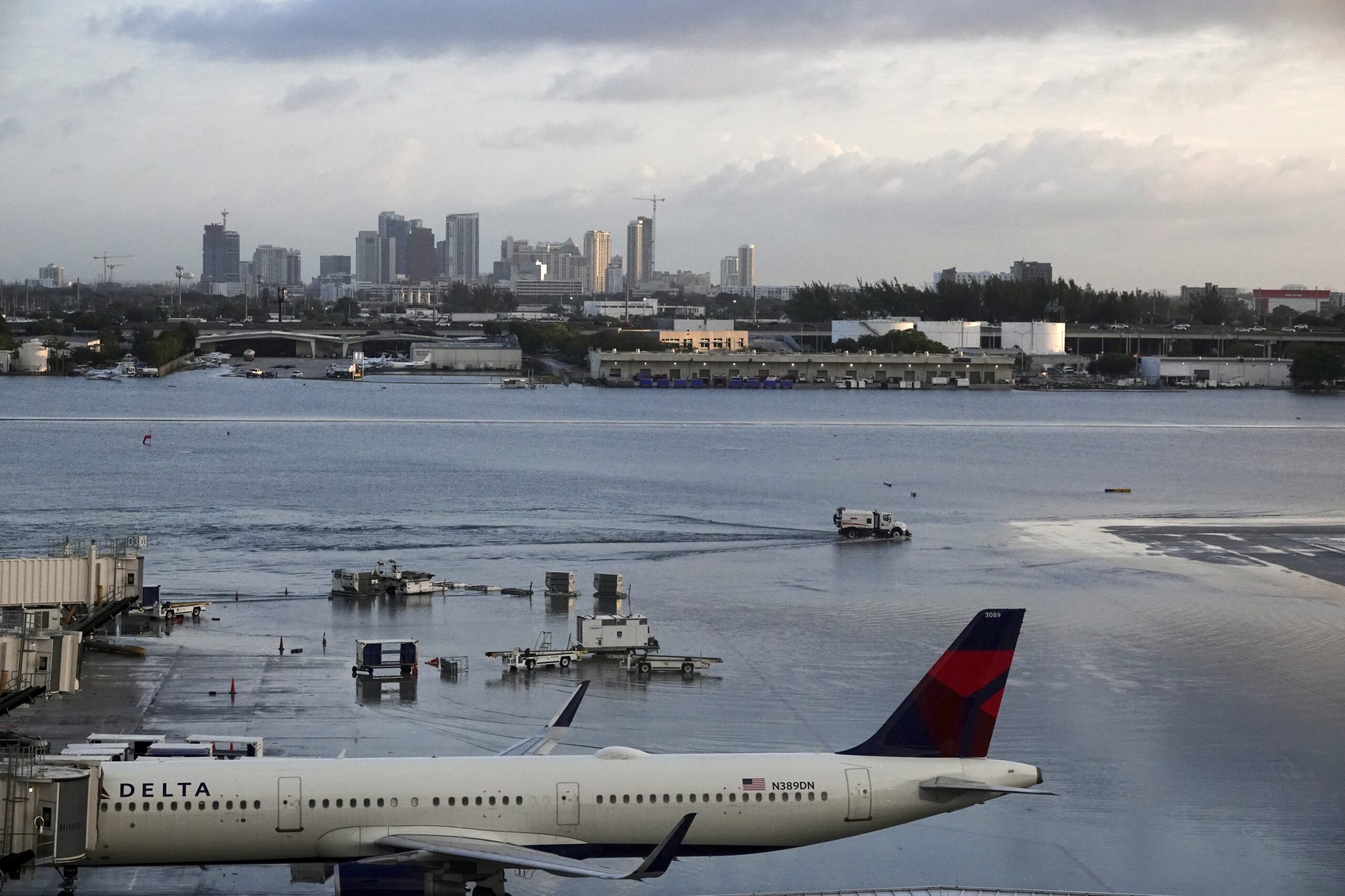 Airplanes sit on the runway due to flooding at Fort Lauderdale Hollywood airport Thursday, April 13...