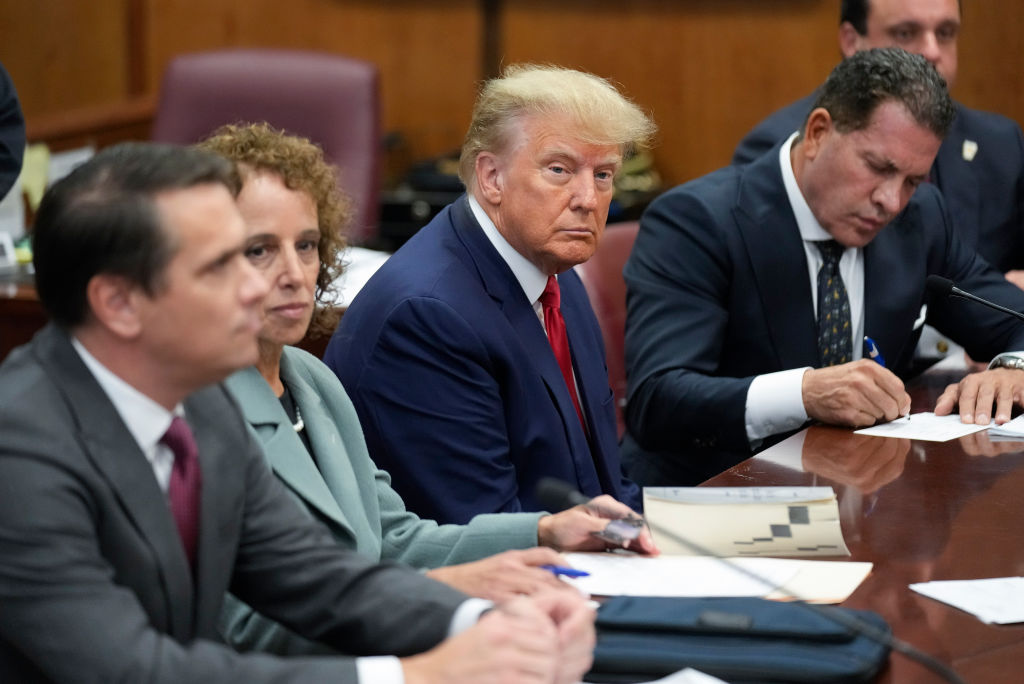 Former U.S. President Donald Trump sits at the defense table with his defense team in a Manhattan c...