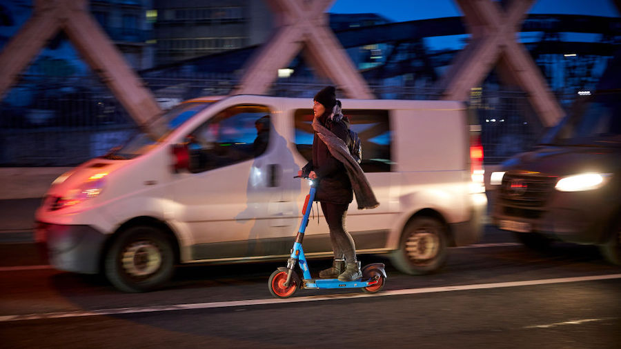 FILE: A Parisian uses an electric scooter to get around the city as Paris is hit by widespread traf...