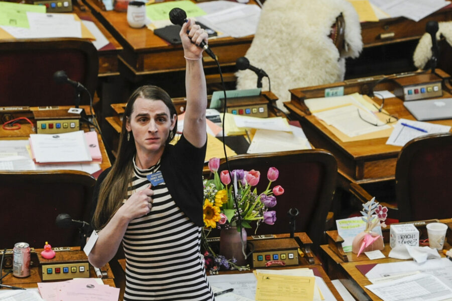 FILE - State Rep. Zooey Zephyr, D-Missoula, alone on the house floor stands in protest as demonstra...
