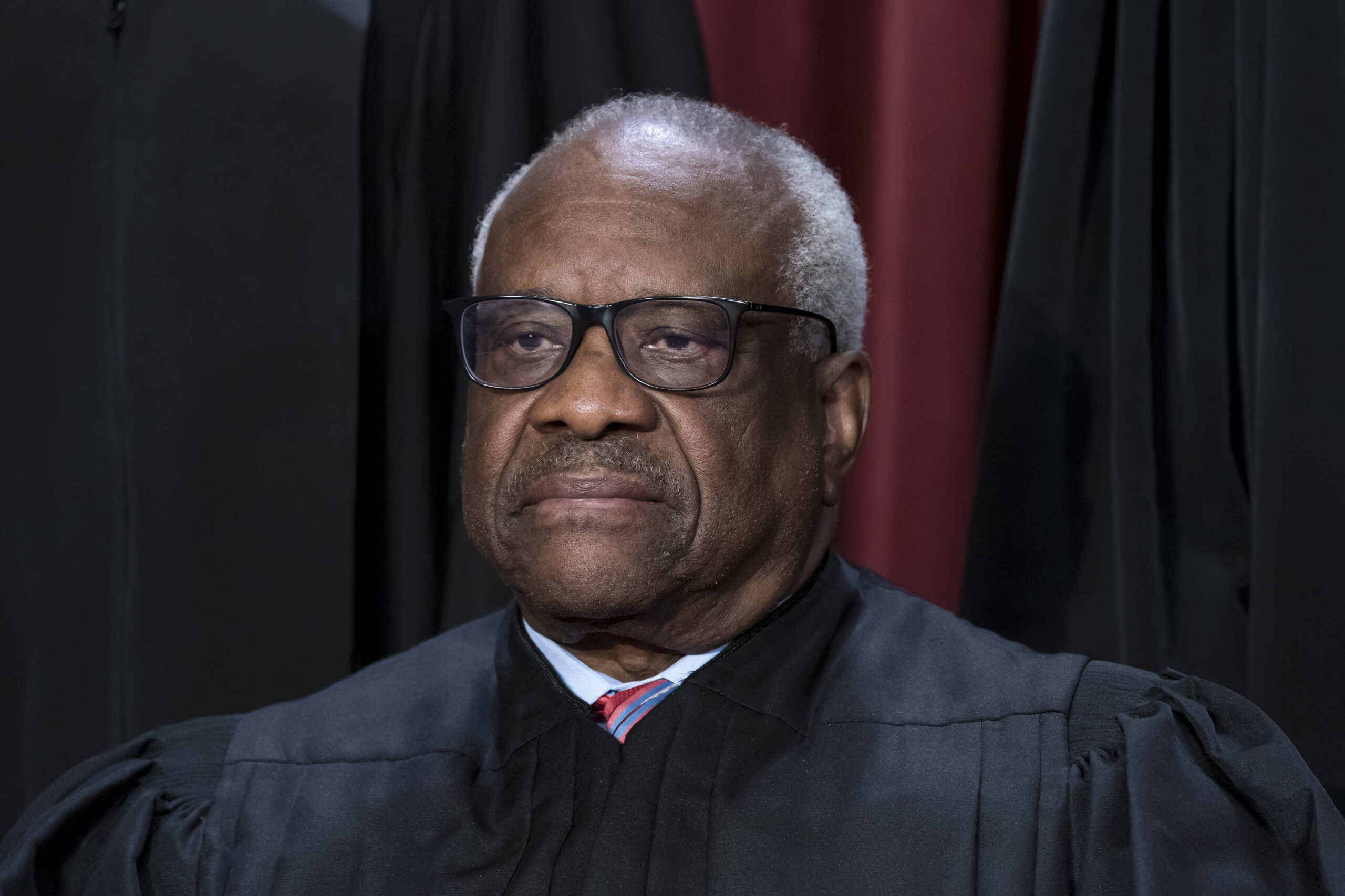 FILE - Associate Justice Clarence Thomas joins other members of the Supreme Court as they pose for ...