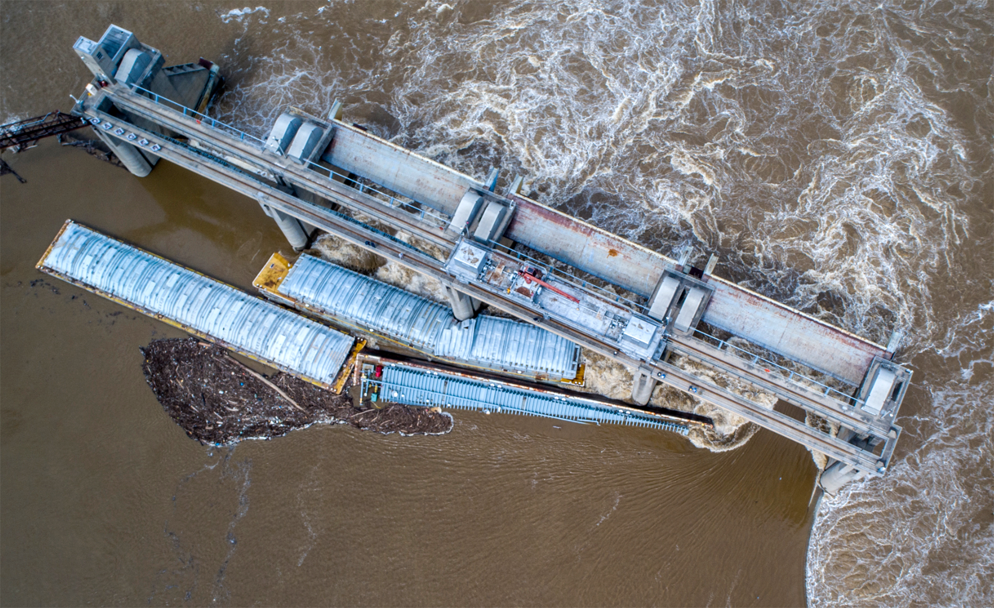 Two barges are stuck against the dam just south of downtown Louisville, Ky., on Tuesday, March 28, ...