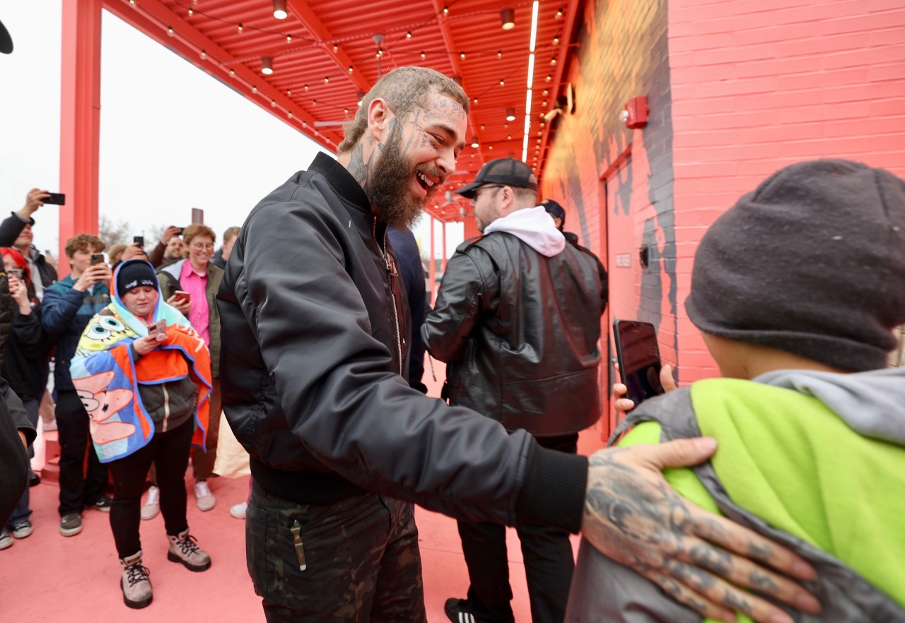 Post Malone greets fans at the new Raising Cane's restaurant, which he helped design. (Photo: Krist...