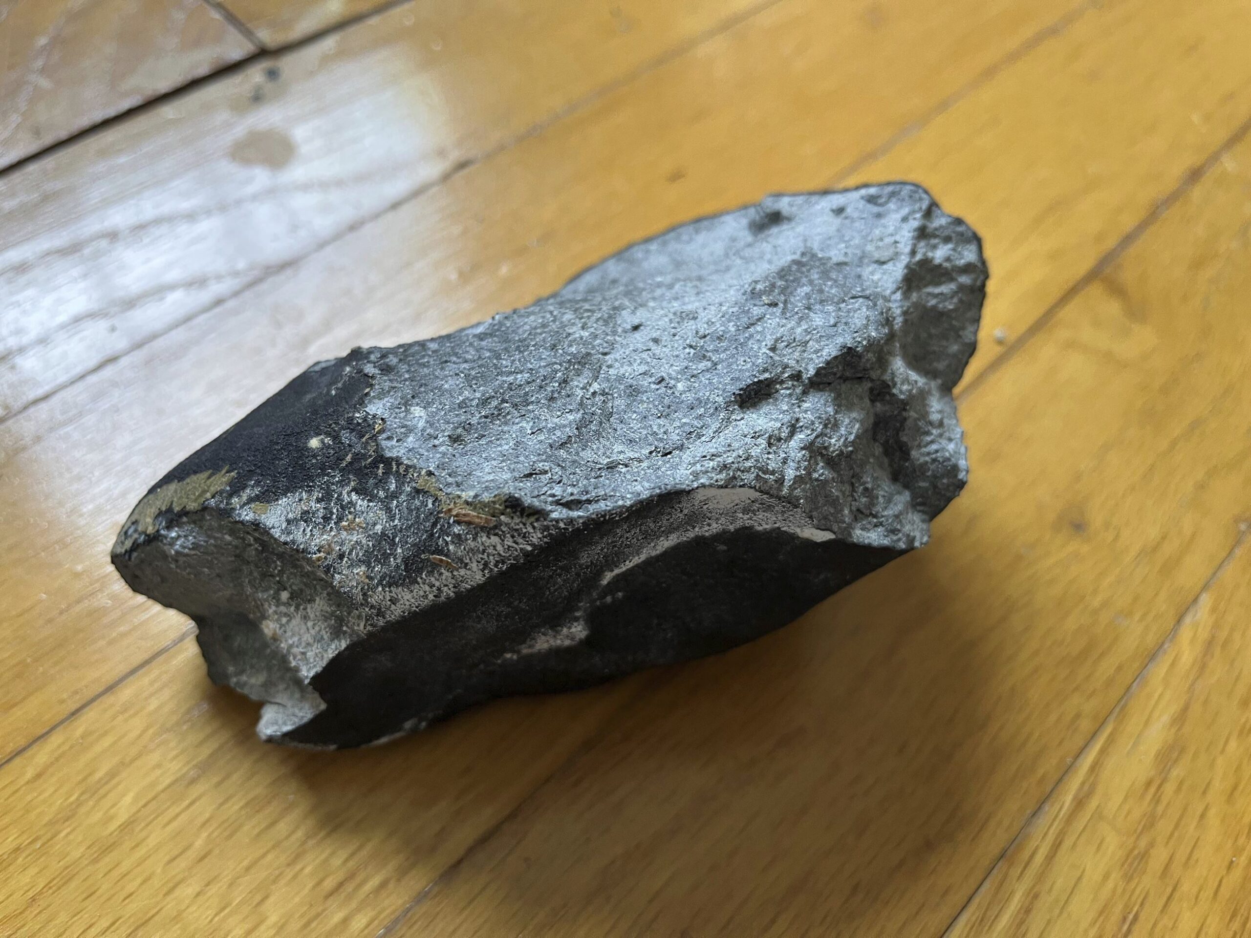 This image provided by Hopewell Township Police Department shows a confirmed meteorite on a hardwoo...