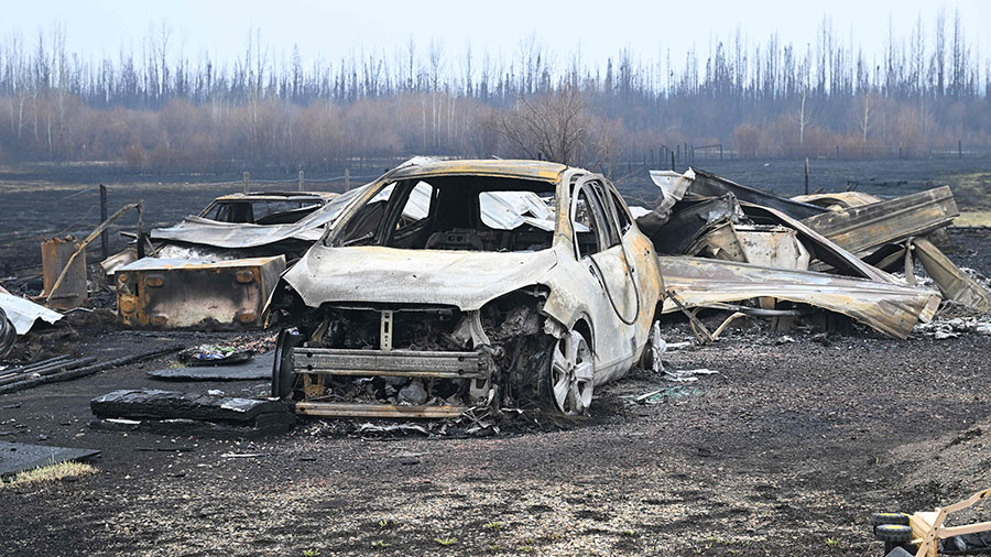 Damaged vehicles sit near the property of Adam Norris, in Drayton Valley, Alberta, Canada, on Monda...