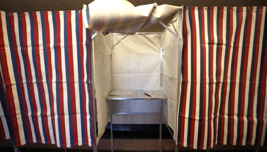 FILE - A booth is ready for a voter, Feb. 24, 2020, at City Hall in Cambridge, Mass., on the first ...