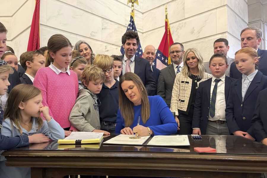 FILE - Arkansas Gov. Sarah Huckabee Sanders signs into law an education overhaul bill on Wednesday,...