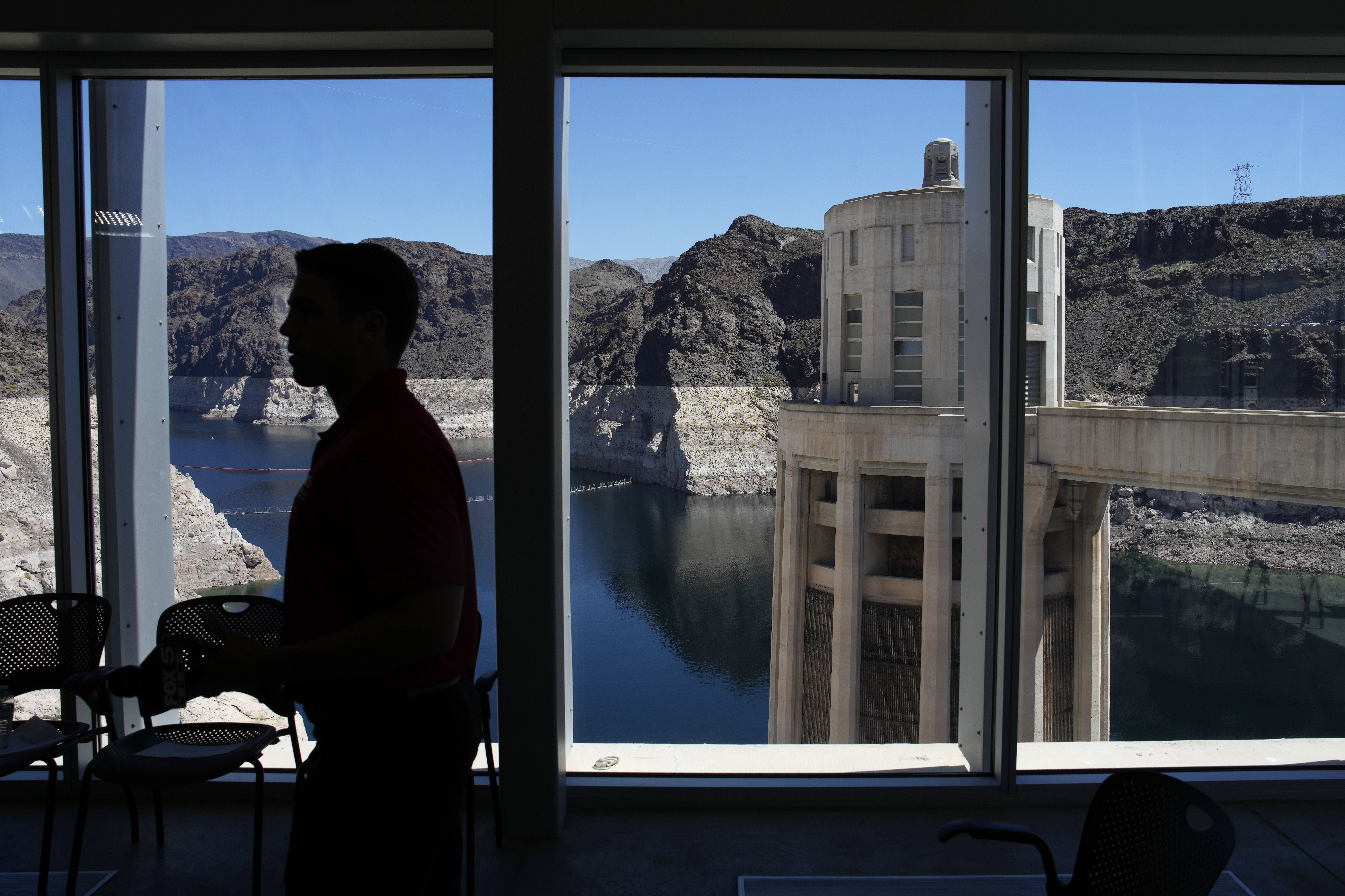 FILE - People attend a news conference on Lake Mead at Hoover Dam, April 11, 2023, near Boulder Cit...