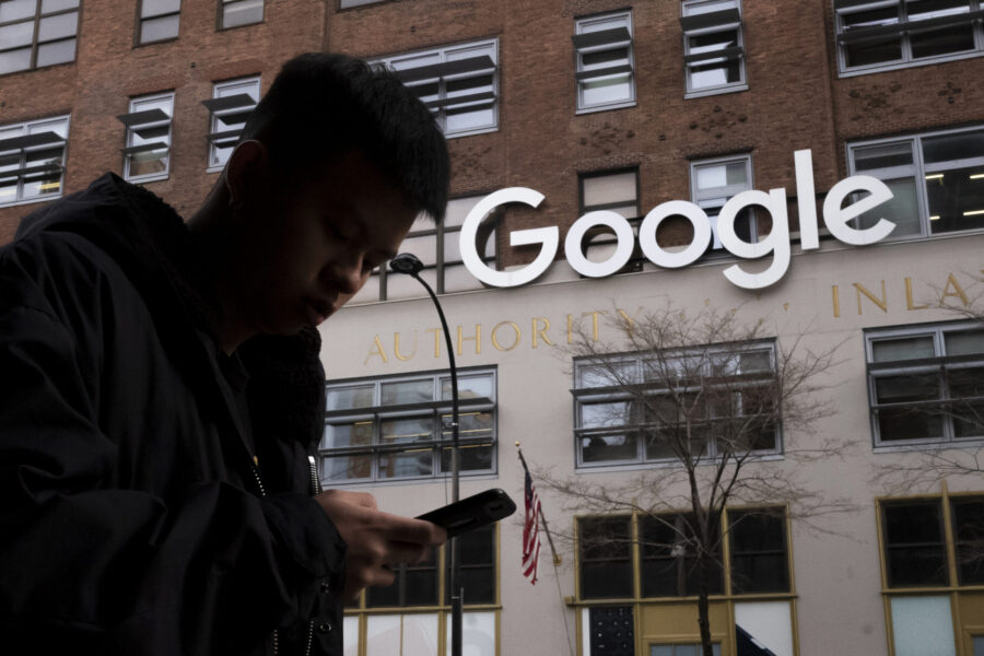 FILE - A man using a cellphone walks past Google offices on Dec. 17, 2018, in New York. On Tuesday,...