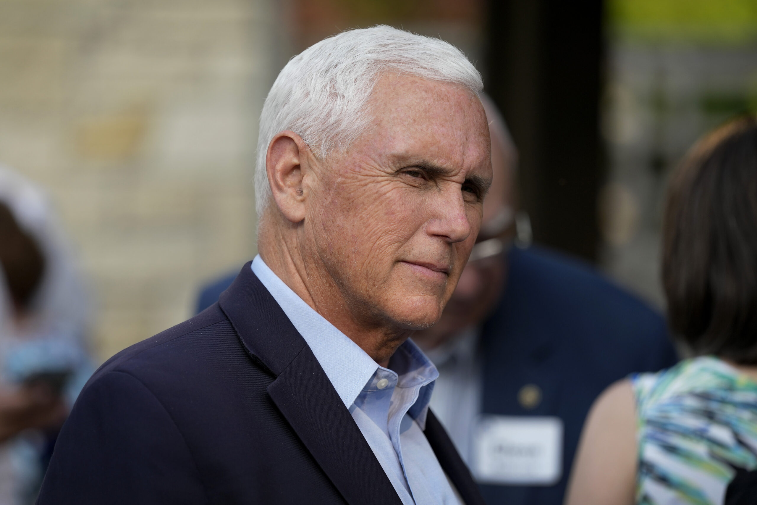 FILE - Former Vice President Mike Pence talks with local residents during a meet and greet on May 2...