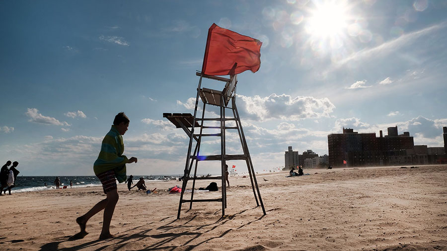 An empty lifeguard chair stands at Coney Island, one of New York City's most popular beach destinat...