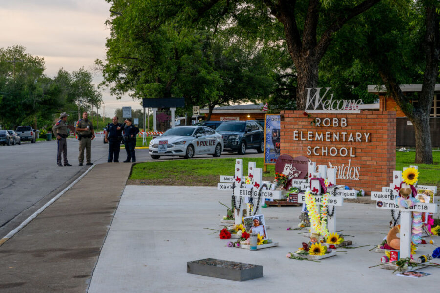 UVALDE, TEXAS - MAY 24: Law enforcement stand watch near a memorial dedicated to the 19 children an...