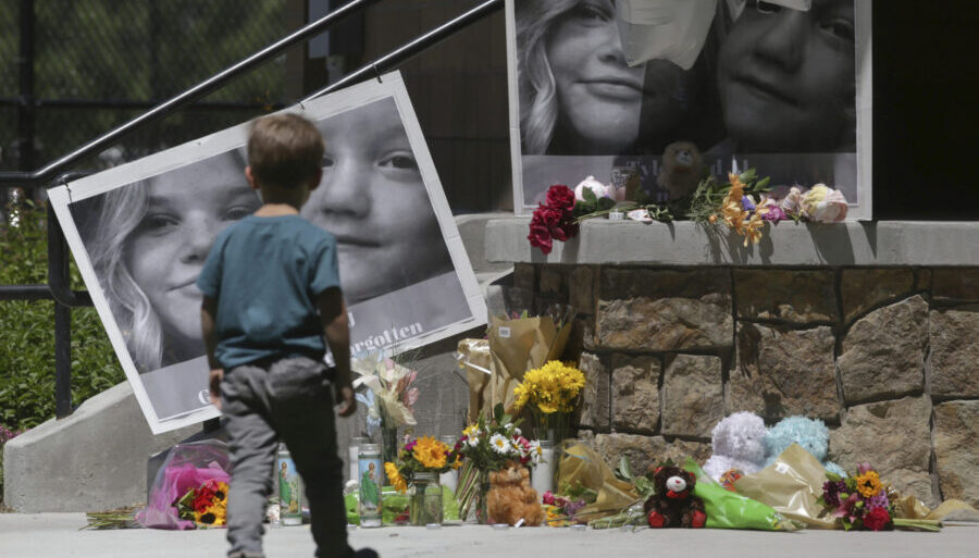 FILE - A boy looks at a memorial for Tylee Ryan and Joshua "JJ" Vallow in Rexburg, Idaho, on June 1...