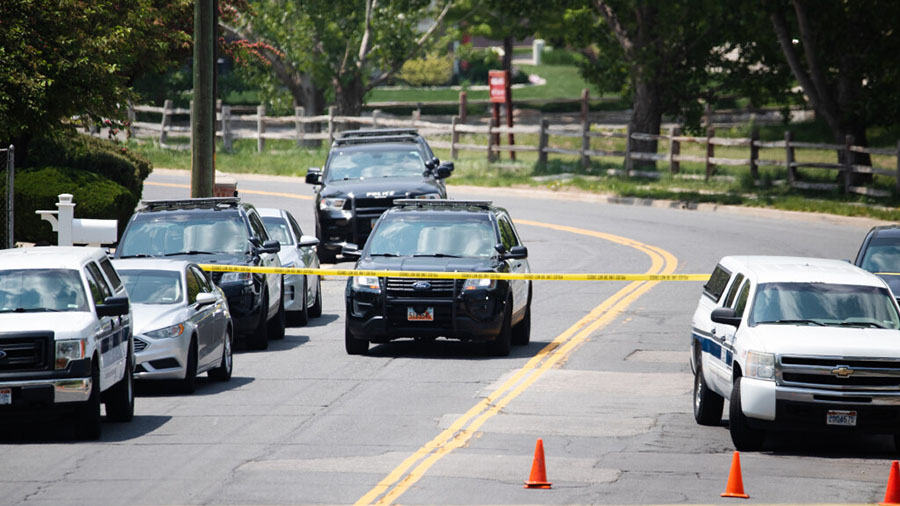 Layton police cars wait outside the scene of a triple homicide in Layton on Friday, May 19, 2023. (...