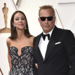 FILE - Christine Baumgartner, left, and Kevin Costner arrive at the Oscars, March 27, 2022, at the Dolby Theatre in Los Angeles. Costner and Baumgartner, his wife of nearly 19 years, are divorcing, a representative for the actor said Tuesday, May 2, 2023. (Photo by Jordan Strauss/Invision/AP, File)