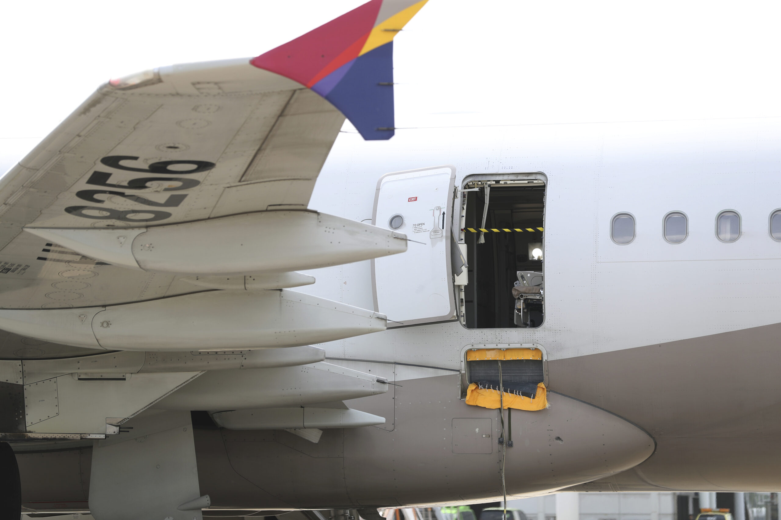 An Asiana Airlines plane is parked as one of the plane's doors suddenly opened at Daegu Internation...