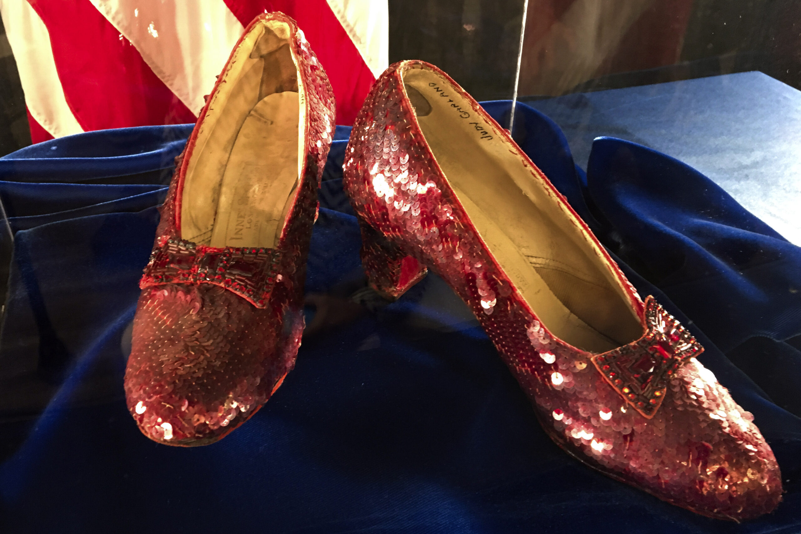 FILE - A pair of ruby slippers once worn by actress Judy Garland in the "The Wizard of Oz" sit on d...