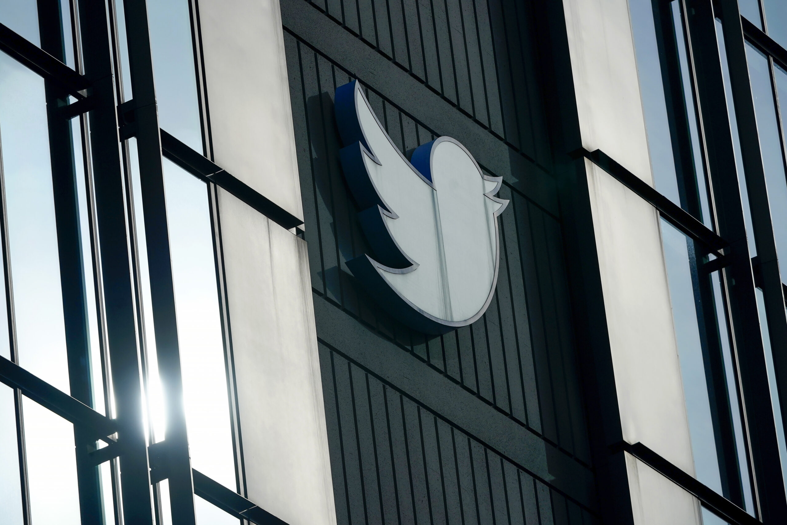 FILE - A Twitter logo hangs outside the company's offices in San Francisco, Dec. 19, 2022. Elon Mus...