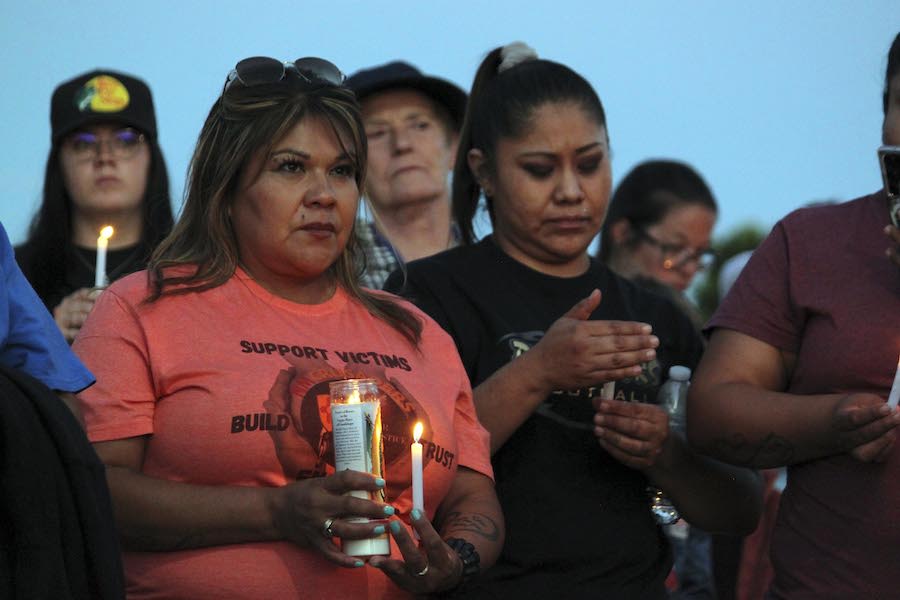 Mourners hold candles Monday during a vigil in Farmington, New Mexico. A 98-year-old woman and her ...
