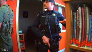 armed officer in a school library 