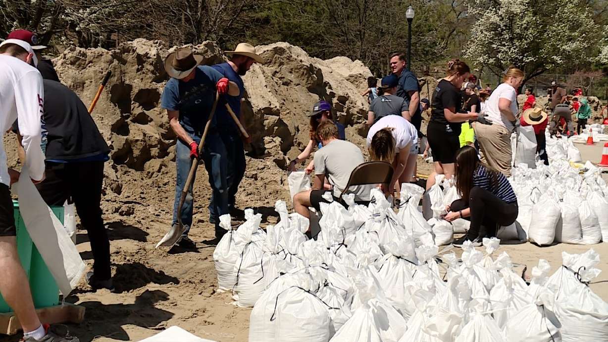 Volunteers help to fill sandbags at Murray Park on April 29. Salt Lake County officials are setting...