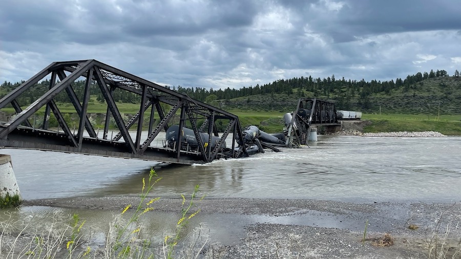 Several train cars are immersed in the Yellowstone River after a bridge collapse near Columbus, Mon...