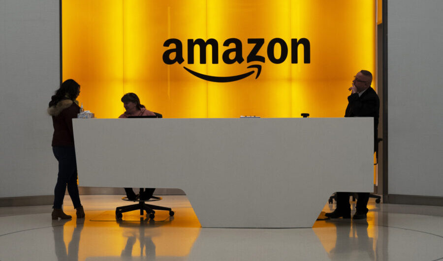 FILE - In this Feb. 14, 2019, file photo people stand in the lobby for Amazon offices in New York. ...