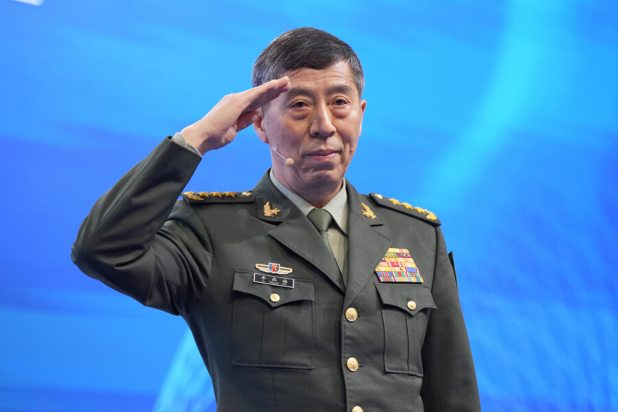 Chinese Defense Minister Li Shangfu salutes before delivering his speech on the last day of the 20t...