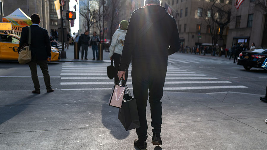 People walk along 5th Avenue in Manhattan, one of the nation's premier shopping streets on February...