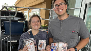Mathew and Lindsey hold pictures saved from the fire