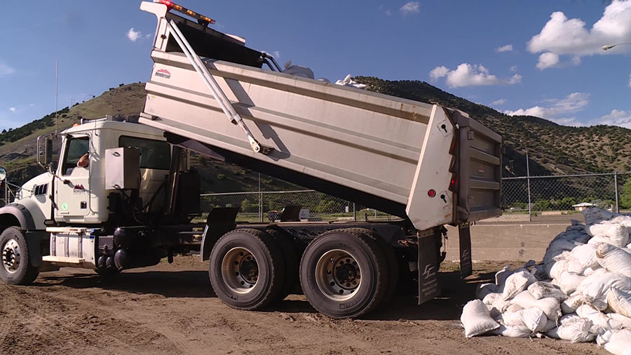 A dump truck moving a dozens of unused sandbags for new recreational areas. (KSL TV)...
