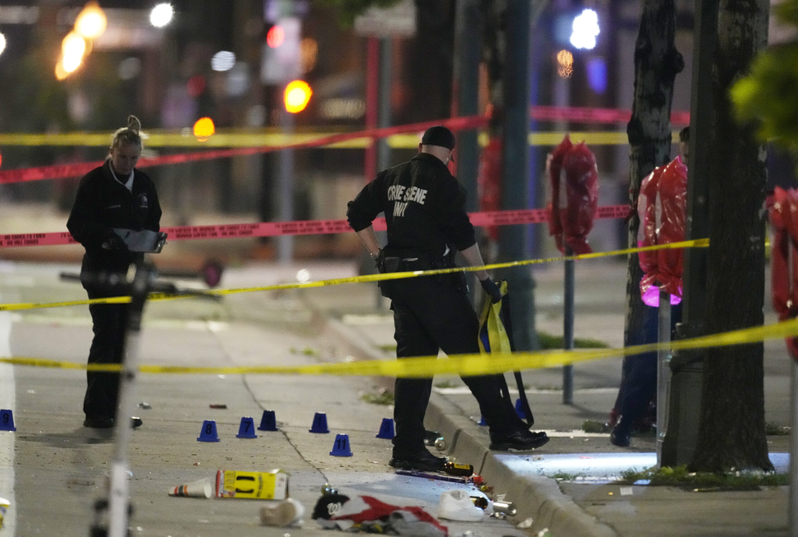 Denver Police Department investigators work the scene of a mass shooting along Market Street betwee...