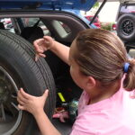 Sarah Miller showing the bullet holes on her car tire. (KSL TV)