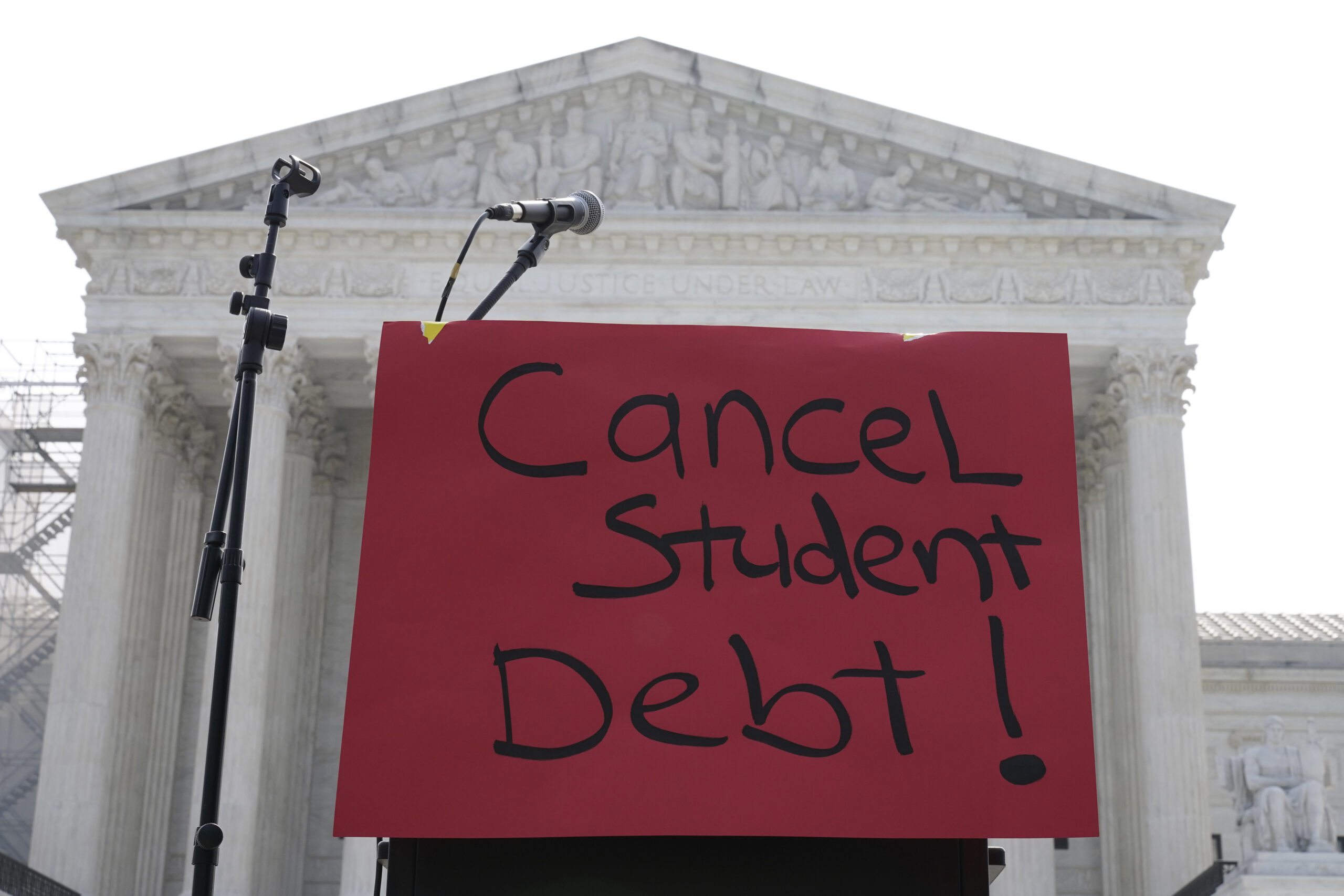 A sign reading "cancel student debt" is seen outside the Supreme Court, Friday, June 30, 2023, as d...