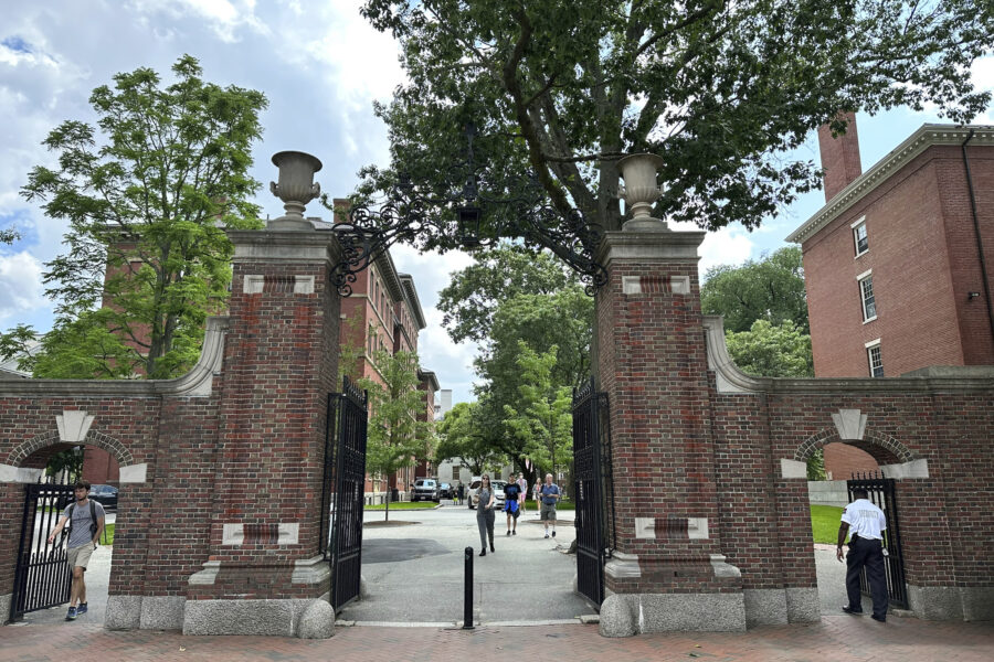 FILE -- Students walk through a gate at Harvard University, Thursday, June 29, 2023, in Cambridge, ...