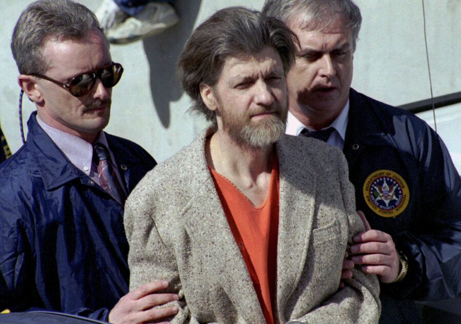 FILE - Theodore "Ted" Kaczynski is flanked by federal agents as he is led to a car from the federal...