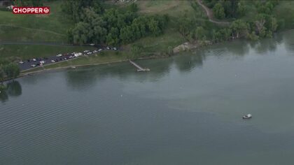 Aerial view of search and rescue crews at Hyrum Dam day beach area.