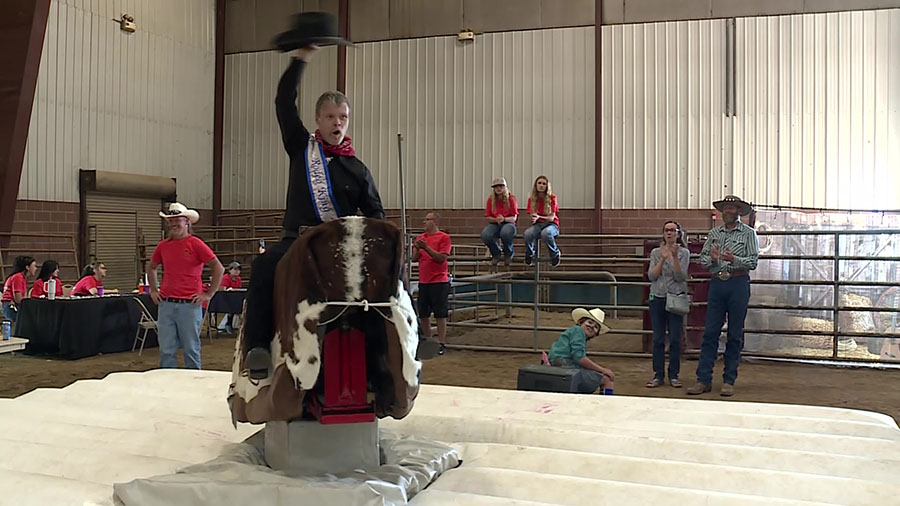 One of the special needs cowboys on a mechanical bull. (Aubrey Shafter, KSL TV)...