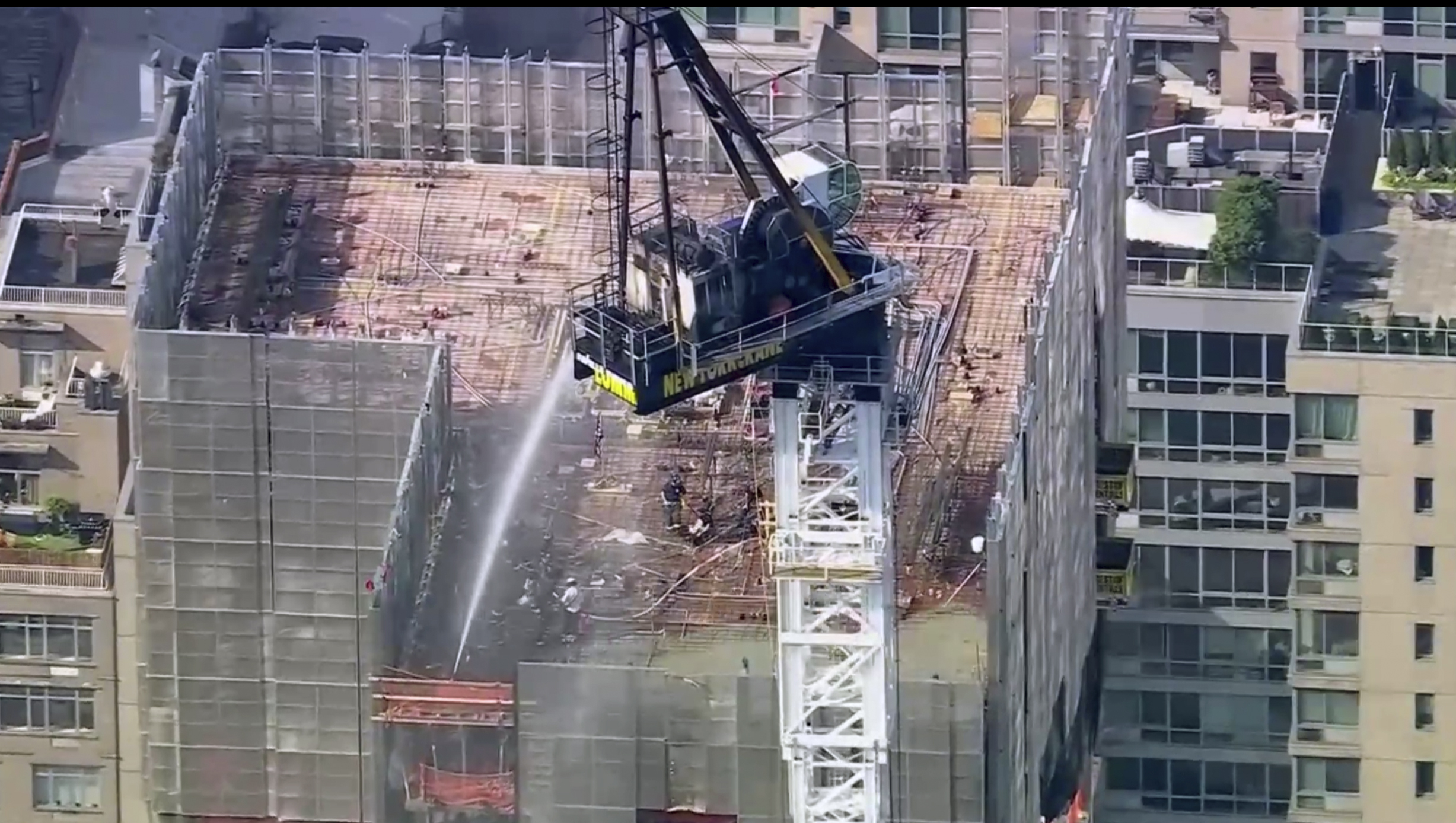 Emergency responders are on the scene after a large construction crane caught fire in Manhattan on ...