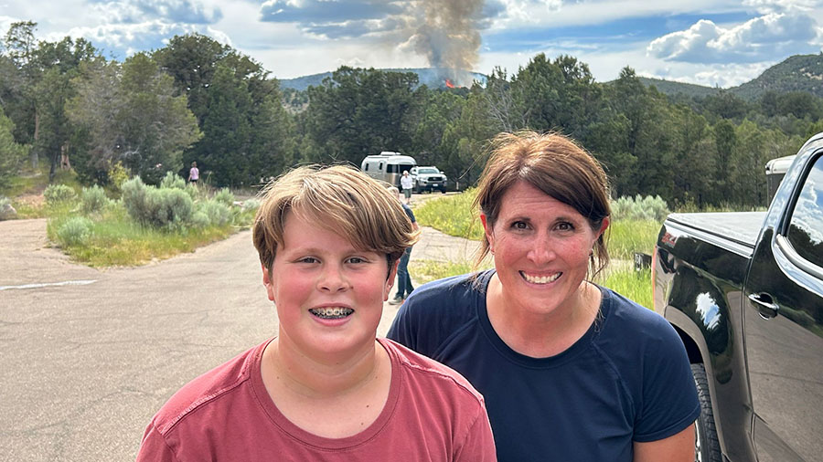 Dawnell Midgley with her family, taking a picture of the smoke behind them as they evacuated their ...