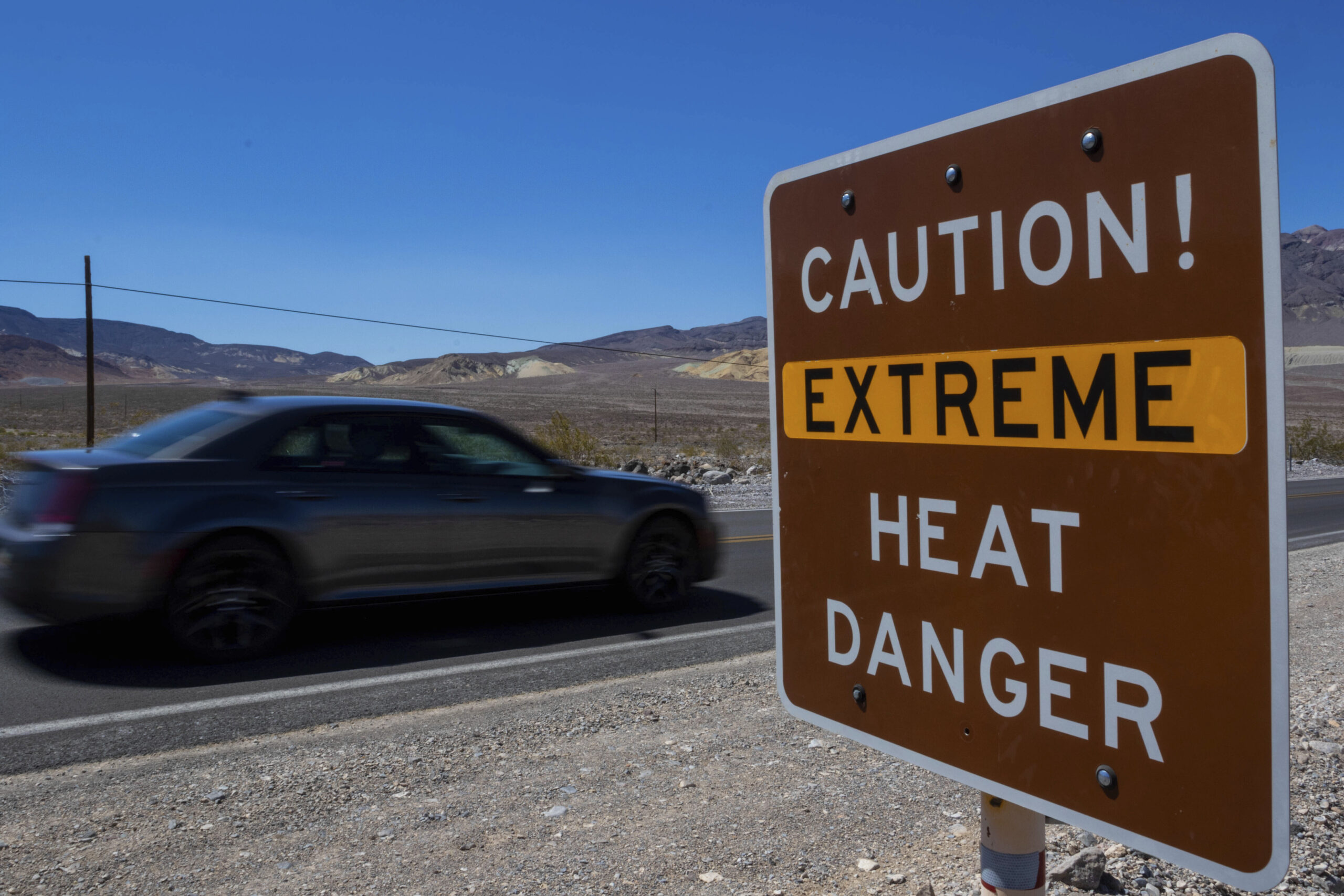 A sign stands warning of extreme heat Tuesday, July 11, 2023, in Death Valley National Park, Calif....