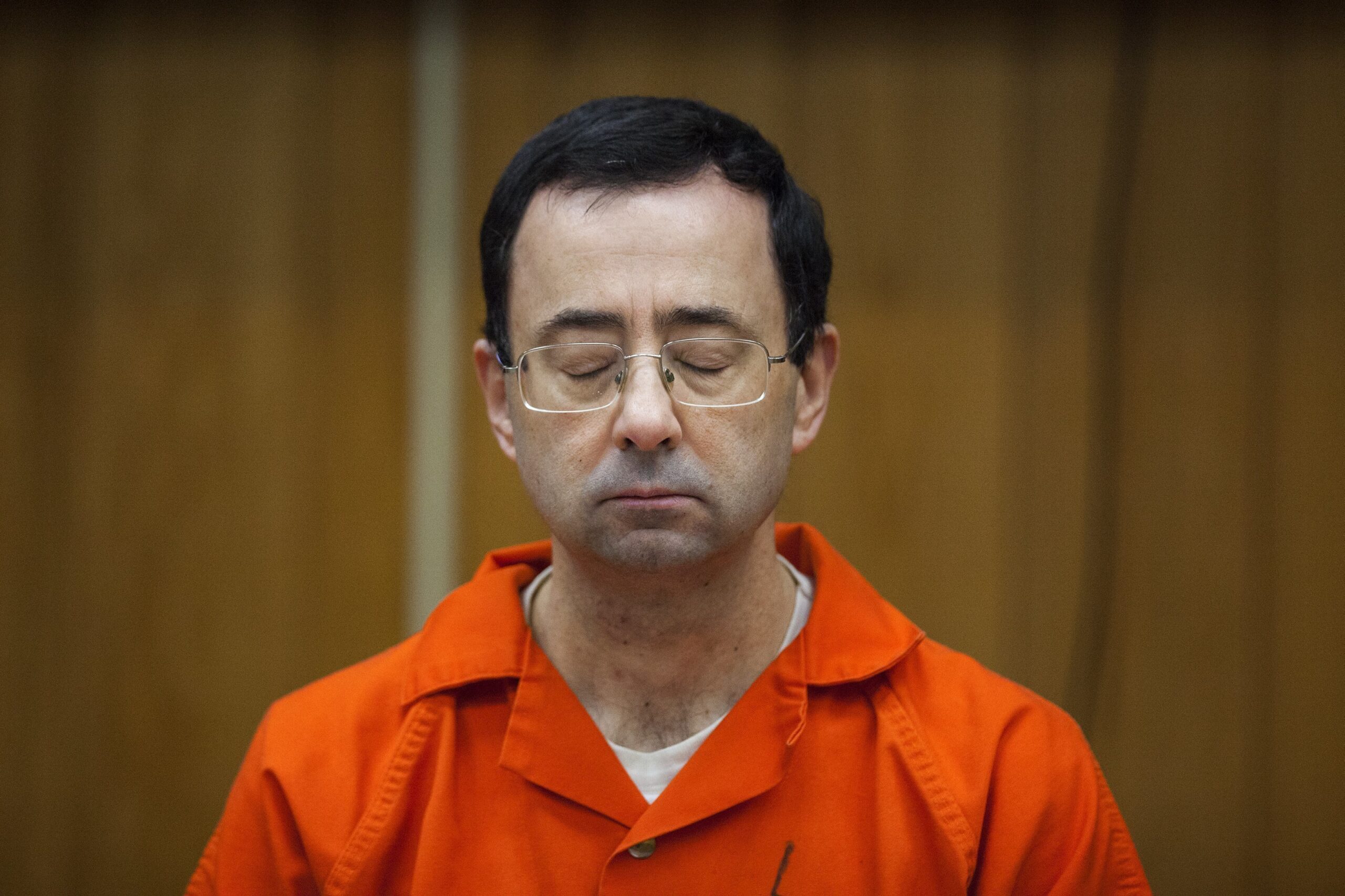 FILE - Larry Nassar listens during his sentencing at Eaton County Circuit Court in Charlotte, Mich....