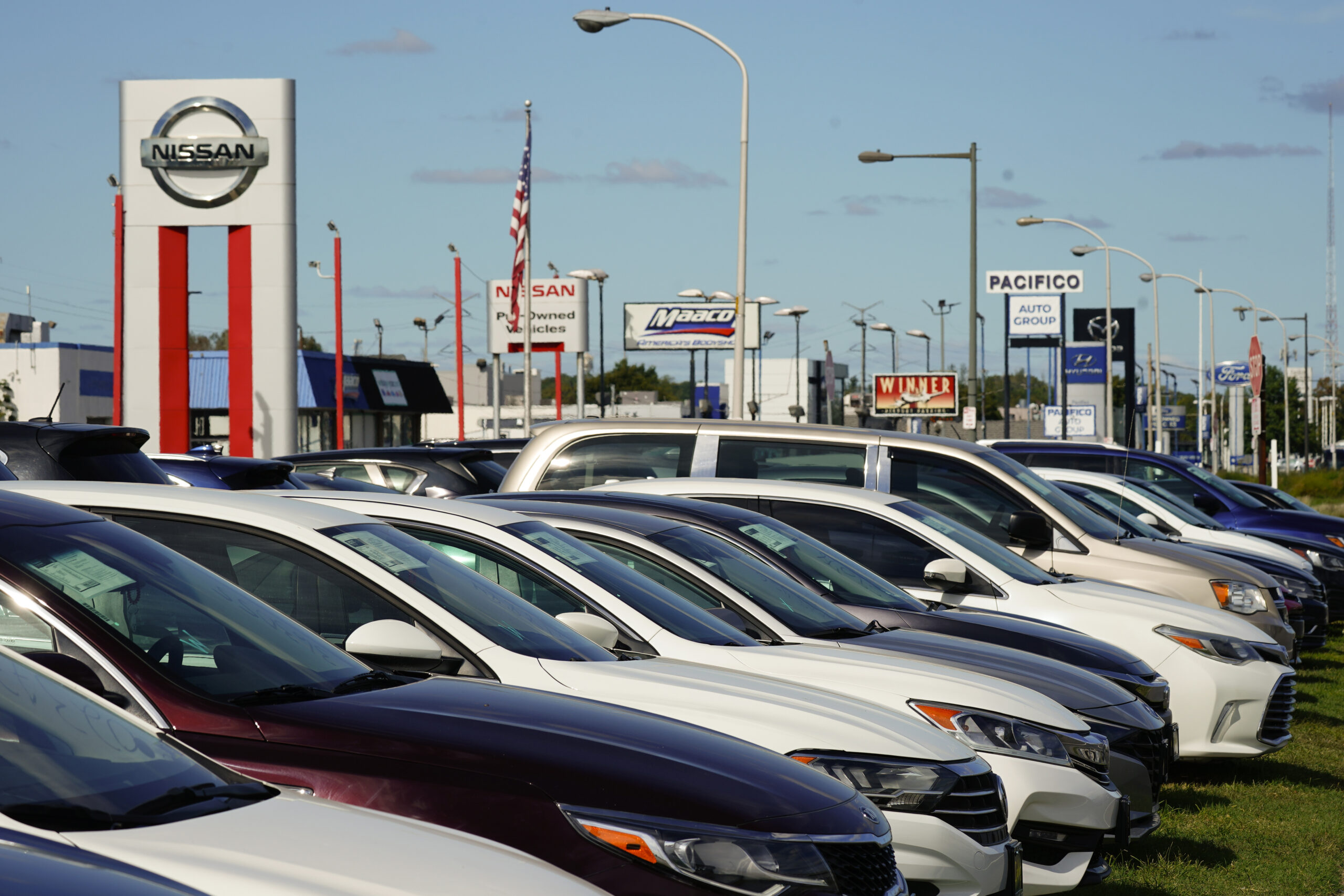 FILE - Cars for sale line the road at a used auto dealership in Philadelphia, Thursday, Sept. 29, 2...