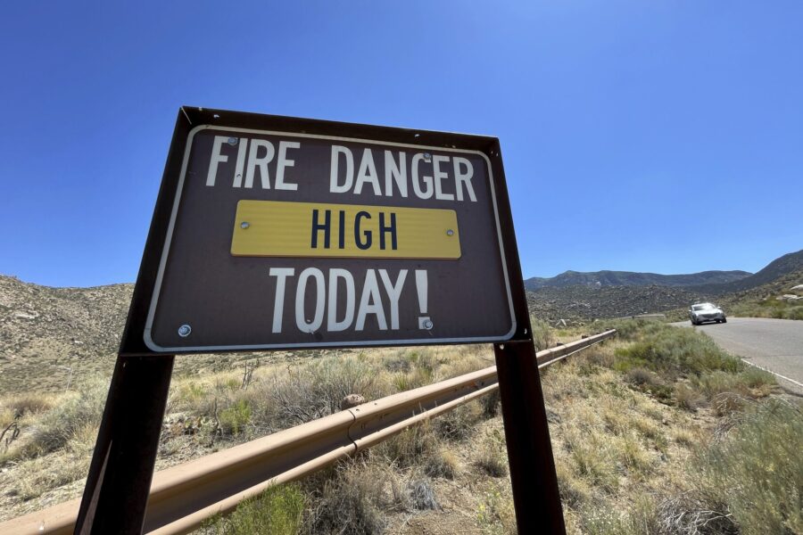 A sign warns that fire danger is high in the foothills of the Sandia Mountains that border Albuquer...