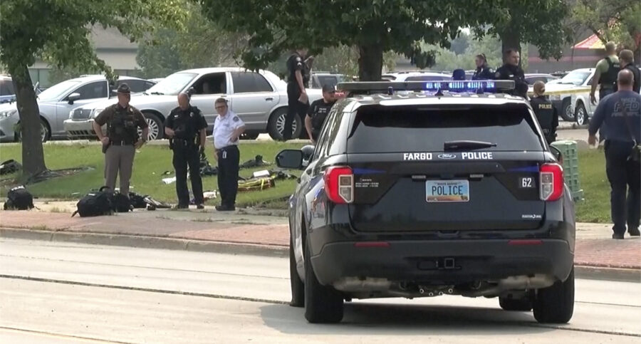 In this image from video, law enforcement officers work at the scene of a shooting Friday, July 14,...