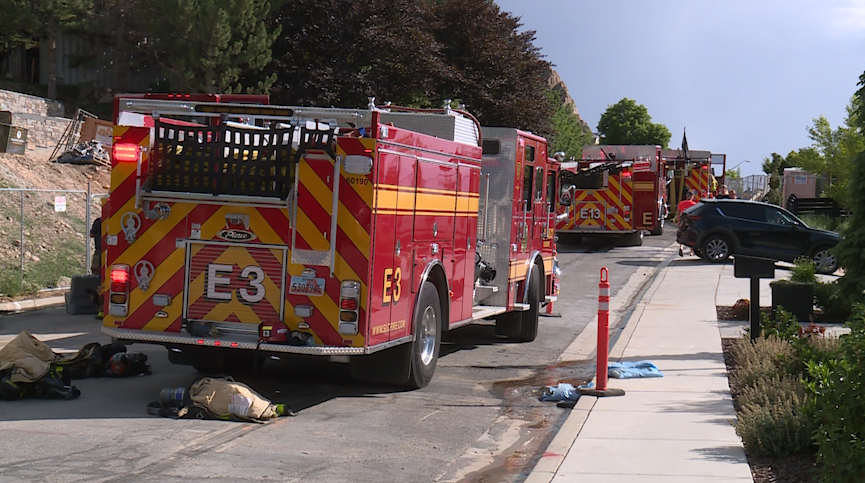 Salt Lake City fire trucks and firefighter gear on the road near the fire. (KSL TV)...
