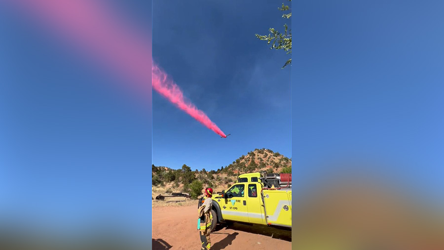 A airplane deploying fire retardant across the fire. (Utah Fire Info)...
