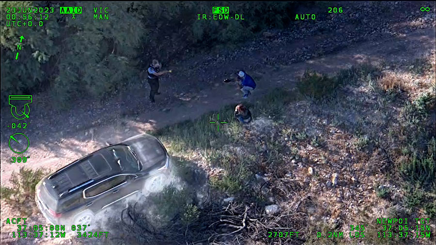 A St. George police officer detaining the two suspects after they drove off the road into the dirt....