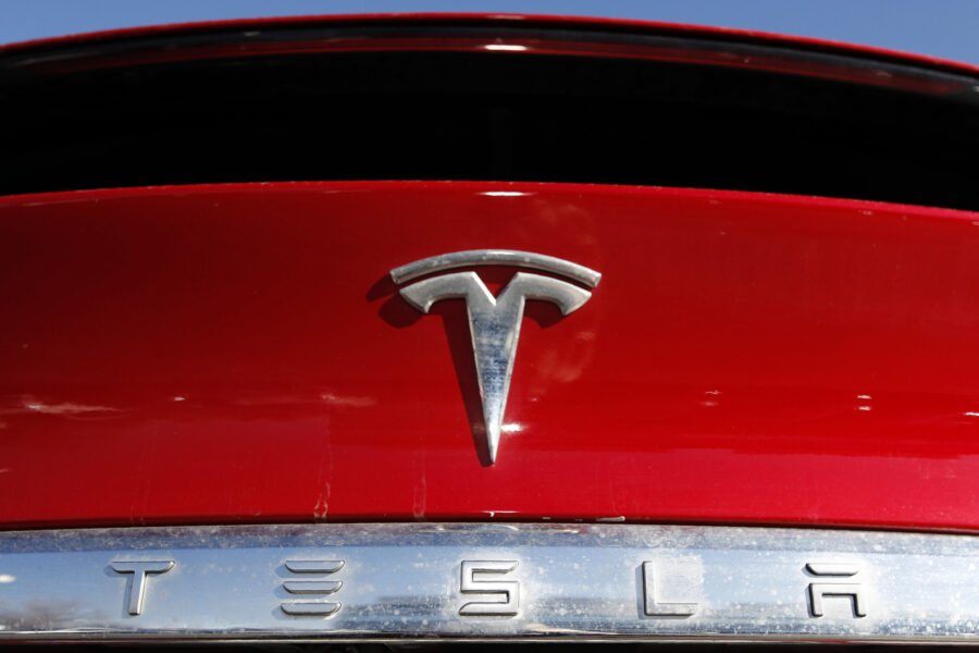 FILE - The Tesla company logo is shown at a Tesla dealership in Littleton, Colo. Feb. 2, 2020. Tesl...