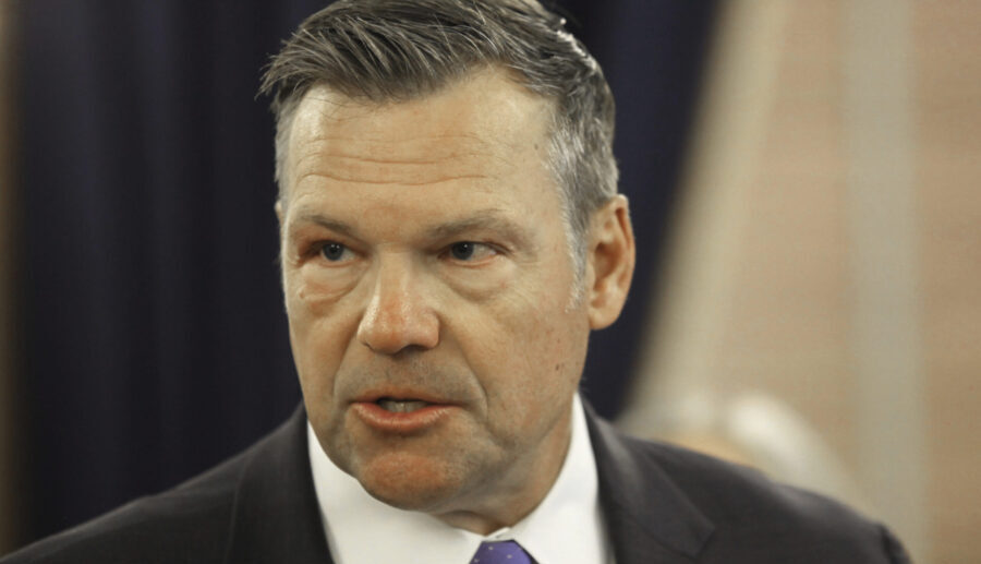 Kansas Attorney General Kris Kobach answers questions during a news conference about a new state la...